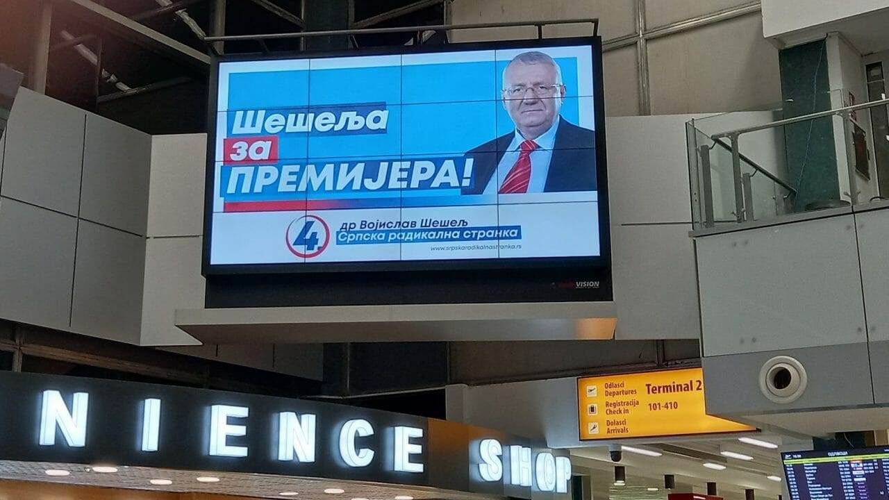 Seselj-advert-on-electronic-billboard-at-Belgrade-airport-scaled-e1646643309660-1280x720-1.jpg