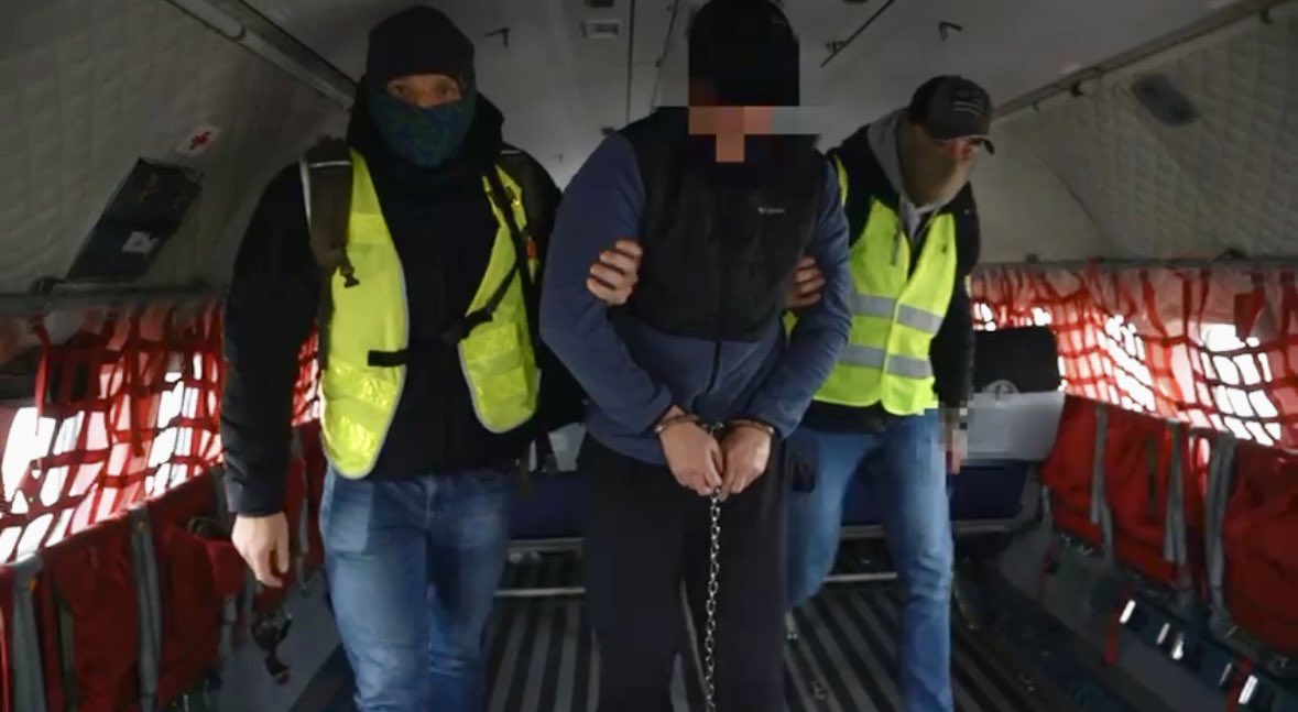 Polish police officers escort Bezrukavyi from a plane after landing in Poland in February 2025. Photo: X/Jacek Dobrzyński, media spokesman for the Minister for the Coordination of Special Services.