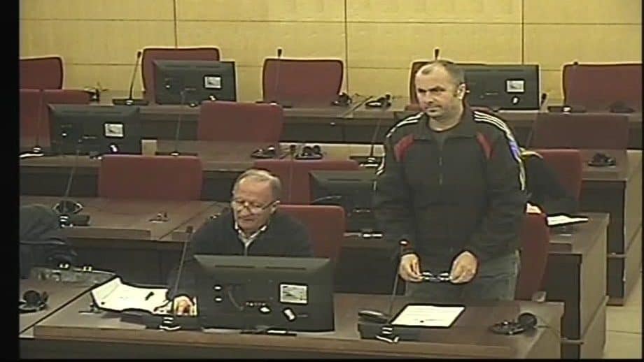 War crimes convict Dragan Janjic (standing) in court during his trial. Video still: Bosnian state court.